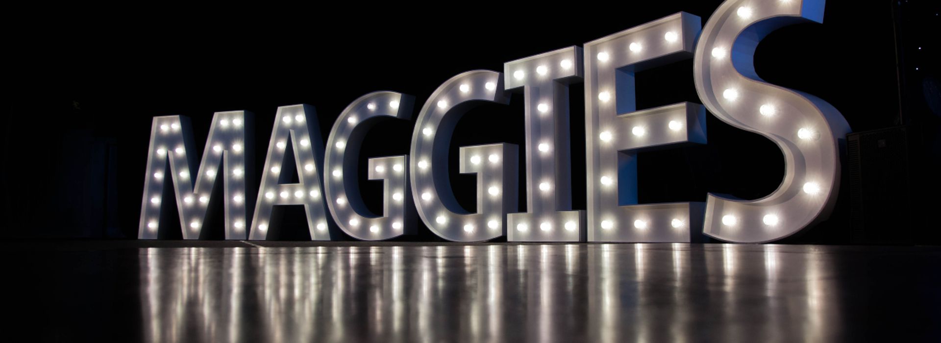 Maggie's in large letters and lights